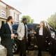 Car salon, sale and rent concept. African and Caucasian men in business wear buying the car. Elegant